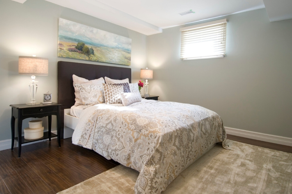 Basement bedroom with wood-look flooring and casual textures | Design by Dvira Ovadia